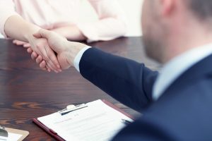 man shaking woman hands