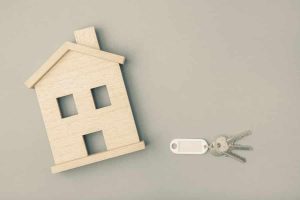 A small wooden house next to a key