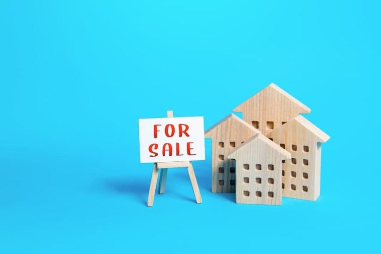 Houses next to a for sale sign