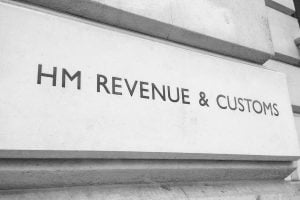 The HMRC Revenue & Customs signage carved into the stone wall of the building