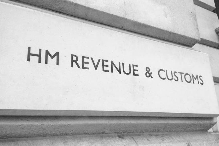 The HMRC Revenue & Customs signage carved into the stone wall of the building