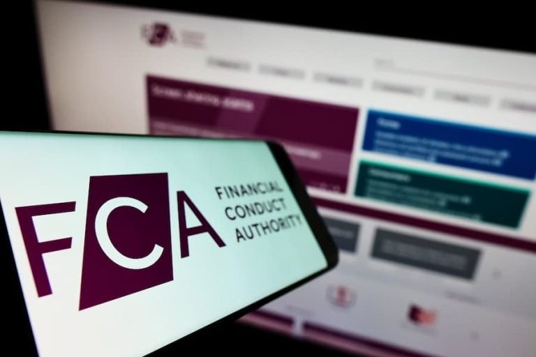 A mobile phone and a computer screen with the FCA home page open