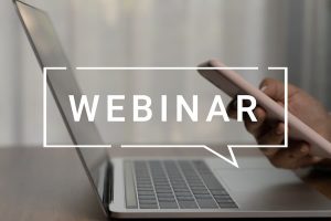 A laptop with the word 'webinar' overlaid in white