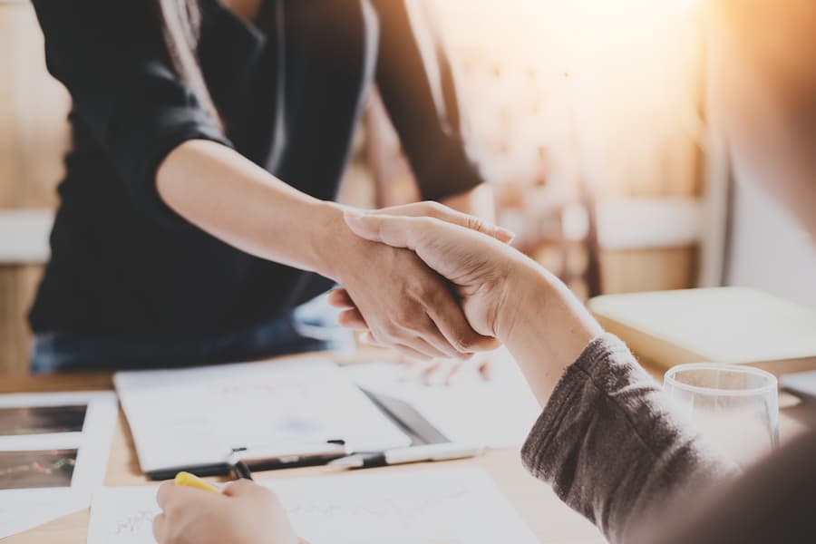 Image of two people shaking hands