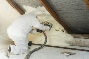 Image of a person spray foaming someone's attic