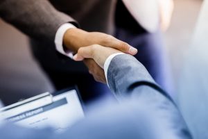 Image of two people shaking hands