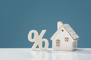 Small model of a house with a percent sign next to it