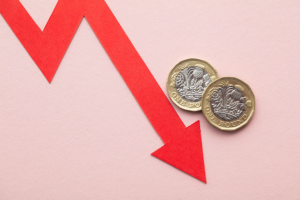 A graphic of a red arrow pointing downwards on a pink background, with two pound coins next to the arrow