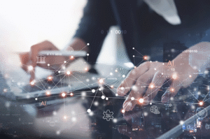 Hands working on a laptop with an overlay of connected lights and dots to illustrate a digital network