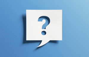 A white piece of paper with a question mark cut out of it, set against a blue background