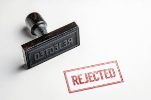 An ink stamp marks the word 'rejected' in red ink on a white background