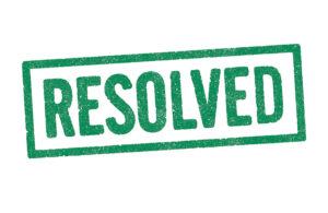 The word 'resolved' stamped in green against a white background