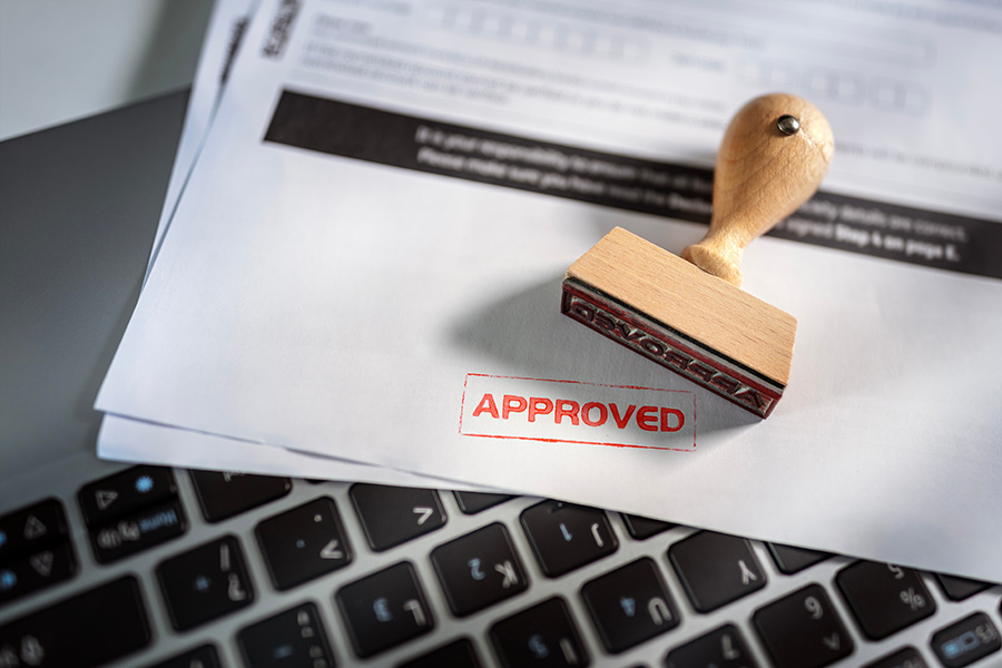 The word 'approved' stamped in red at the bottom of a form