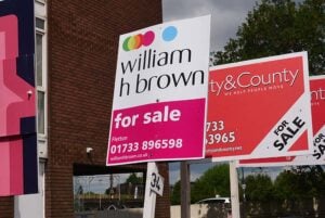 A row of for sale signs outside flats in Peterborough
