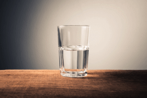A photograph of a glass filled halfway with water