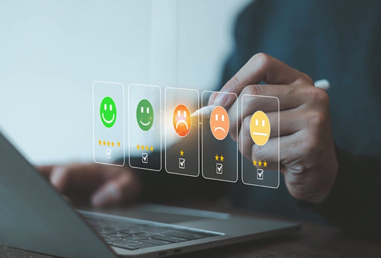 Five smiley faces ranging from happy to sad, with a finger pointing at the face in the middle