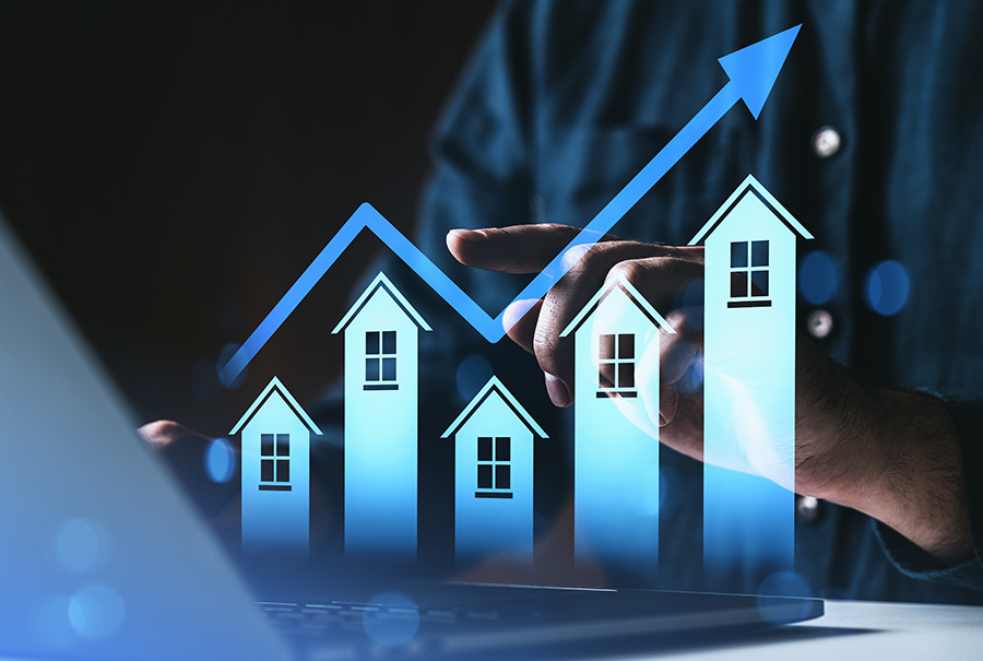 A graphic of a row of neon houses above a laptop keyboard, with an arrow pointing upwards over the top of the houses