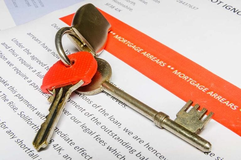A letter headed 'mortgage arrears' with a set of keys on top of it
