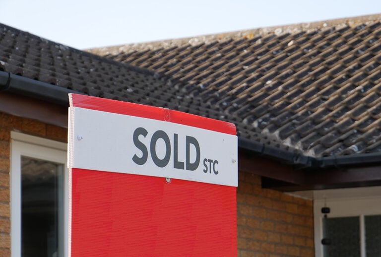 A sign outside a house with the words 'sold stc'