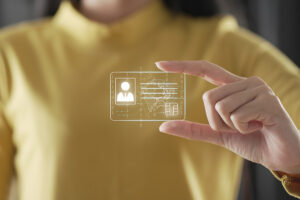 A woman appears to be holding a holographic image of an ID card