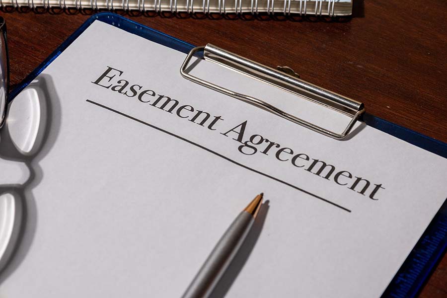 A clipboard with the words 'easement agreement' written at the top
