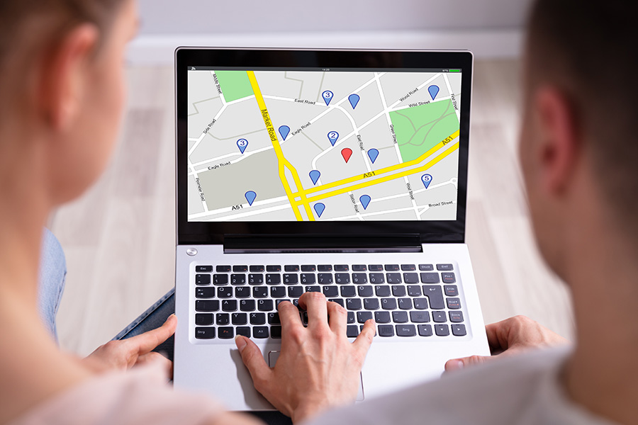 A couple look at a map on a laptop