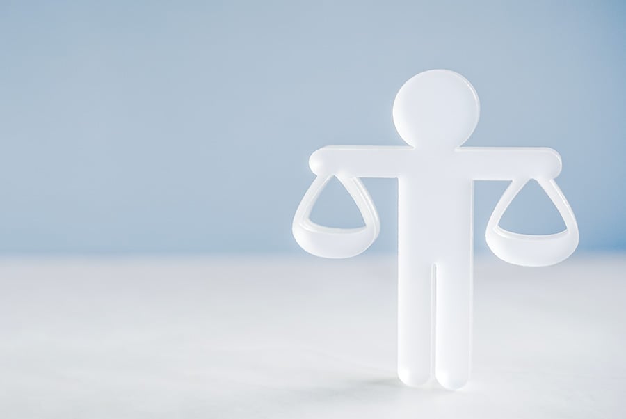 A simple white figure with outstretched arms holding scales, against a white/blue background