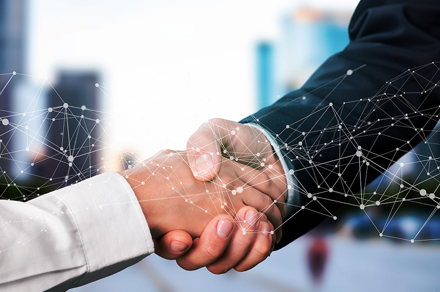 Close-up of a handshake overlaid with a series of connected digital lights