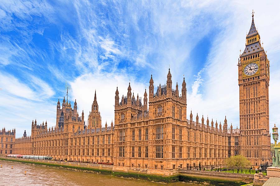 Westminster surrounded by blue sky and white whispy clouds