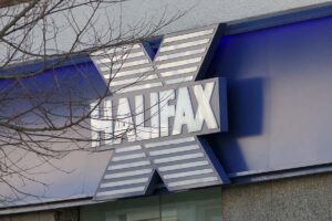 A close-up of a Halifax sign, with the bare branches of a tree in winter in the foreground
