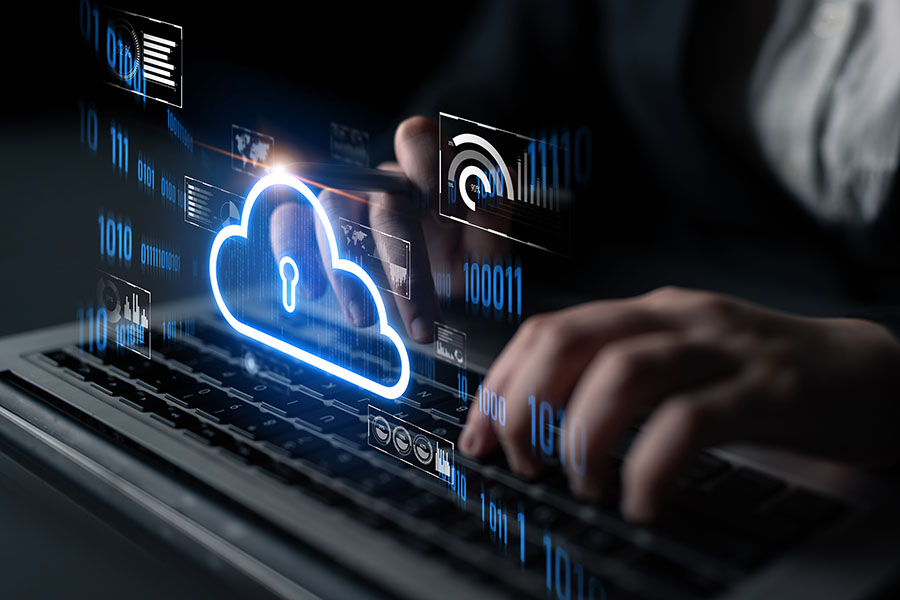 A close-up of hands on a keyboard overlaid with a graphic of a simple cloud surrounded by document and graph symbols