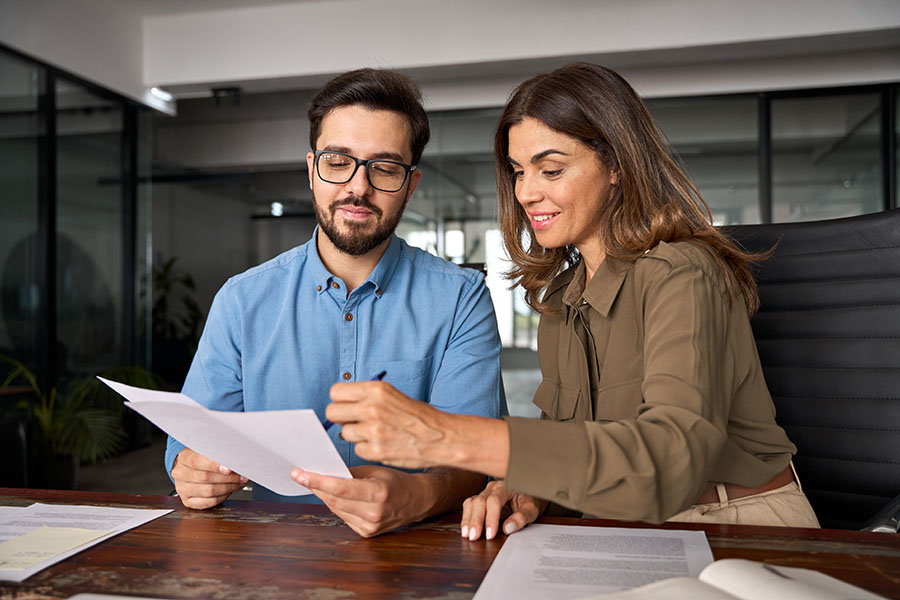 Colleagues at a desk looking at papers