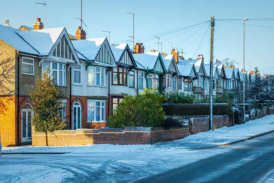 A row of terraced houses covered in frost and snow