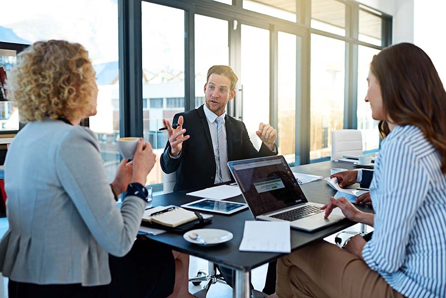 Three lawyers in a meeting room with a large window