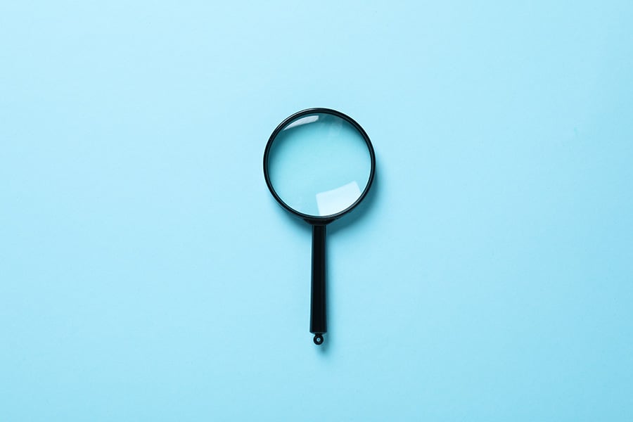 A simple magnifying glass on a blue background