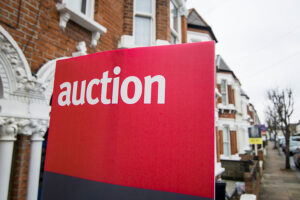 An auction sign outside a house