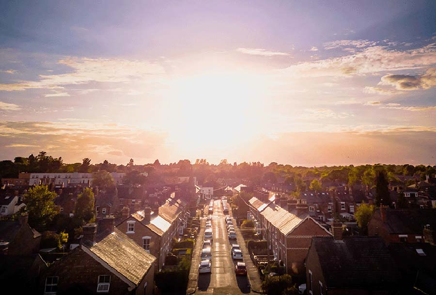 The sun rises over a street of terraced houses