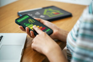 A close up of hands holding a phone with an EPC rating on the screen