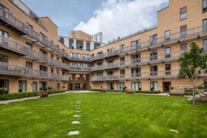 A block of flats with a large communal garden