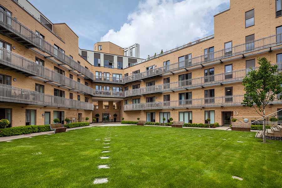 A block of flats with a large communal garden