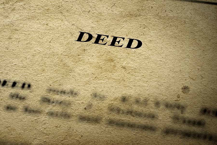 An old-looking official document with the word 'deed' on the header