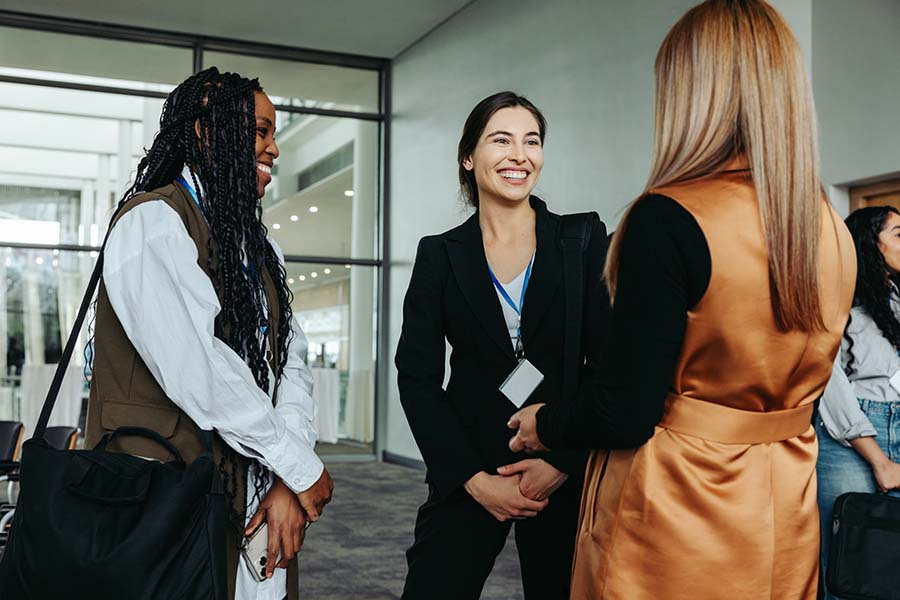 A group of women smiling and talking