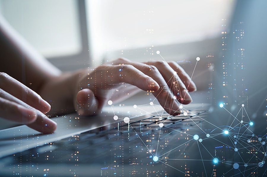 Hands on a keyboard with an overlaid graphic of lots of connected lights