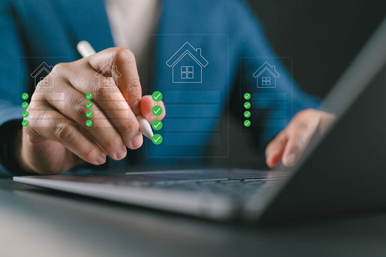 A close-up of hands working on a laptop overlaid with a graphic of a tick-list of items