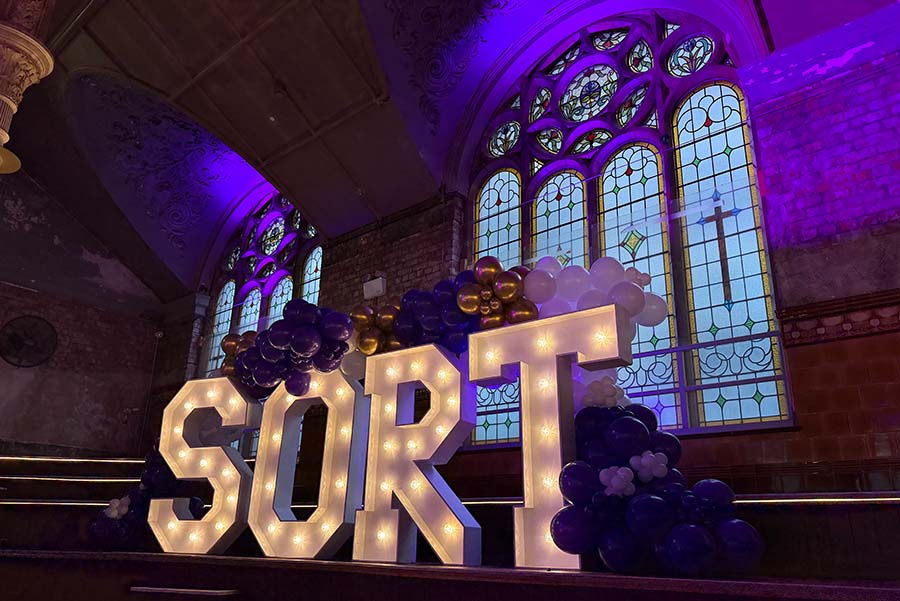 A large neon sign spelling out the word 'sort'