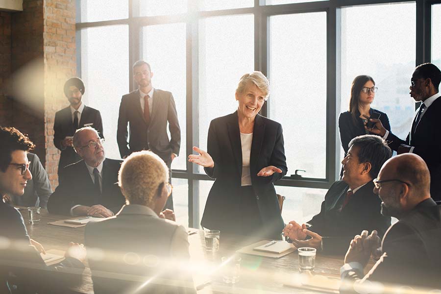 A diverse group of people having a discussion in a boardroom