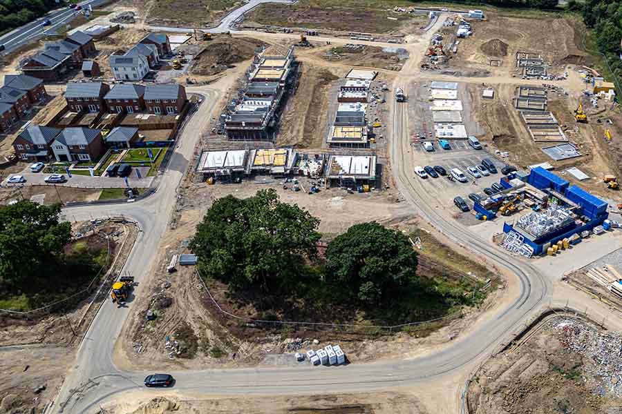 An aerial view of a large housing development in the early stages of construction