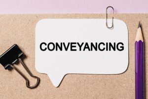 A file marked conveyancing with a pencil and paperclip on it