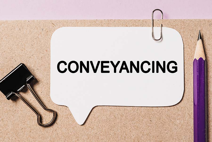 A file marked conveyancing with a pencil and paperclip on it