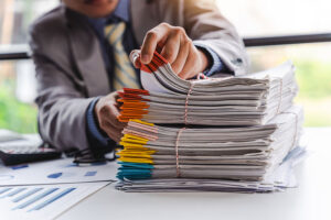 A large stack of files on a desk